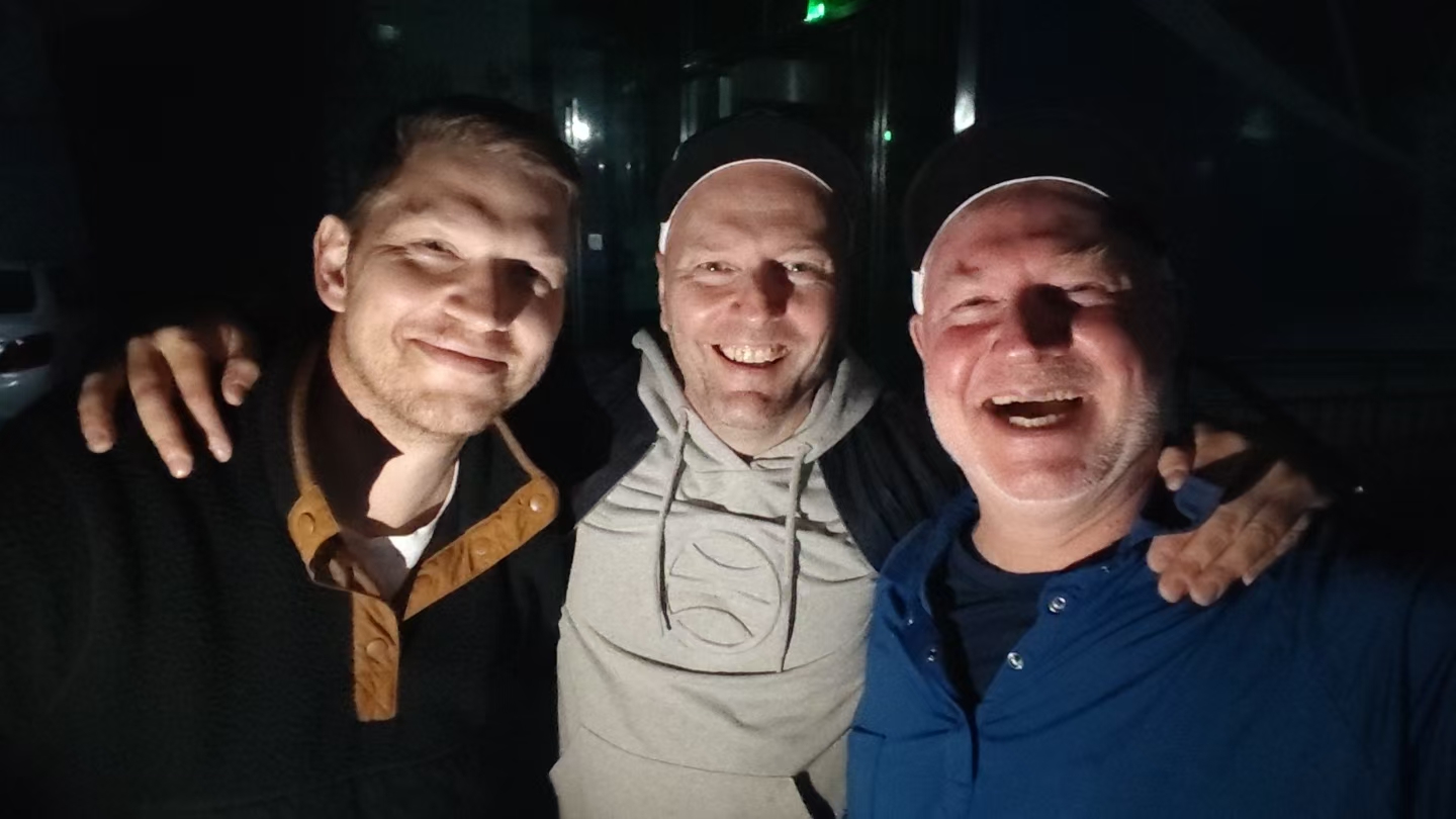 Three friends together in the parking lot, celebrating the friendships at the heart of BIIH