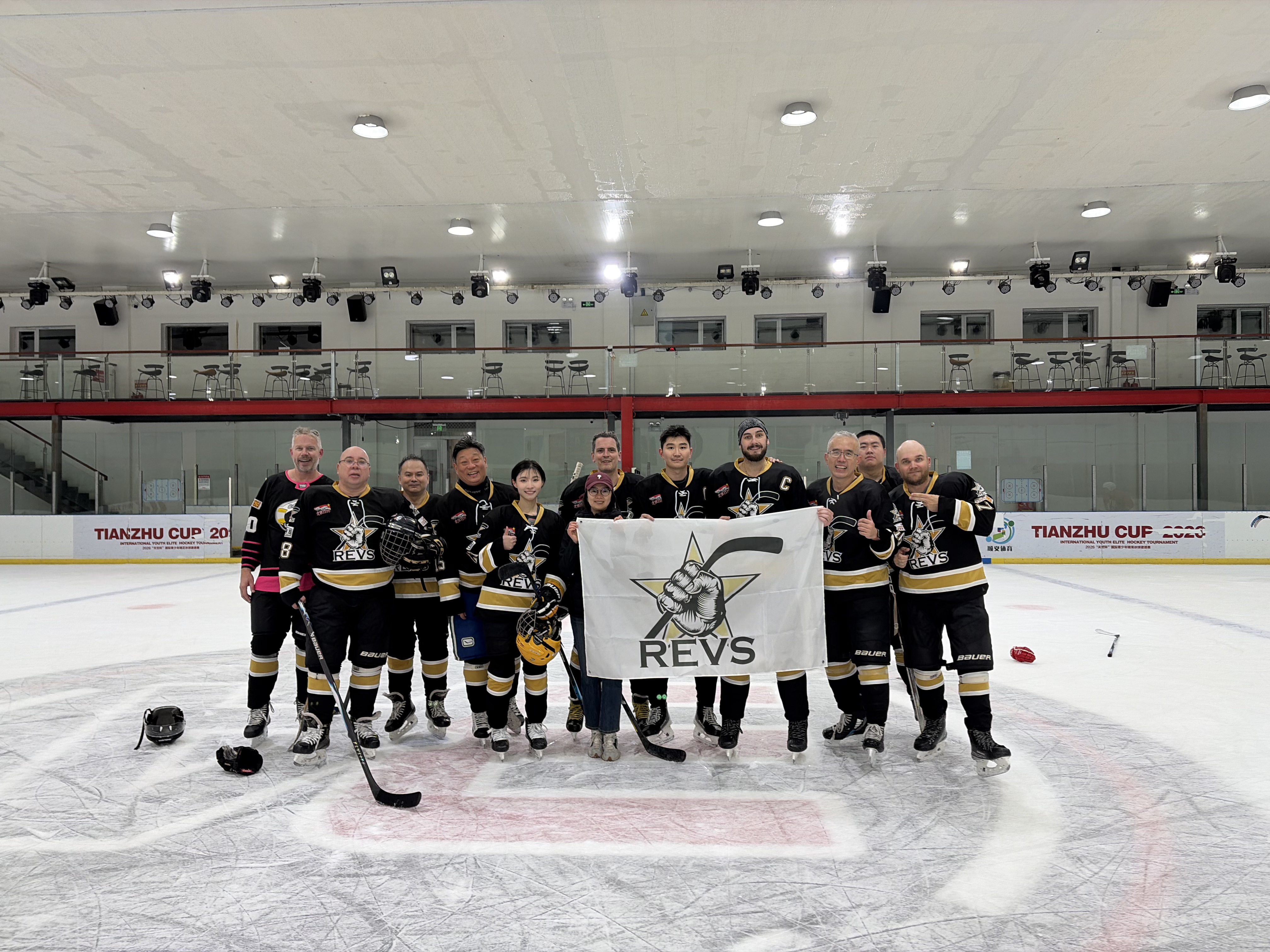 Revs players together on the ice with their team flag at a bye-week pickup game